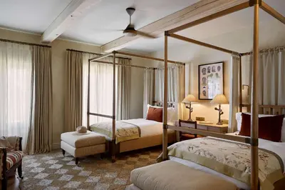 a bedroom with two beds and a canopy bed at Spier Hotel and Wine Farm in Stellenbosch