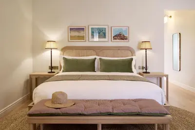 a bedroom with a large bed with a hat on it at Spier Hotel and Wine Farm in Stellenbosch