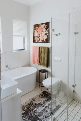 a bathroom with a tub and a toilet and a sink at Between the Ocean and Winelands in Croydon