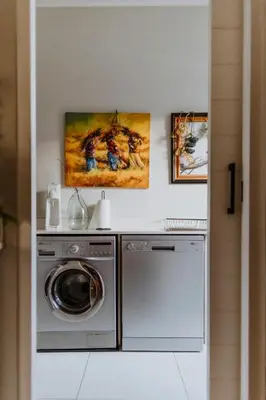 a laundry room with a washer and dryer at Between the Ocean and Winelands in Croydon