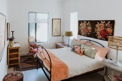 a bedroom with a bed with an orange blanket on it at Between the Ocean and Winelands in Croydon