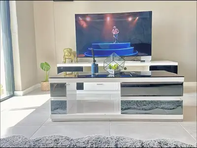 a white entertainment center with a tv in a living room at Beach Front in Cape Town