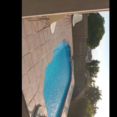 a large blue swimming pool in a building at S&R Guesthouse in Cape Town