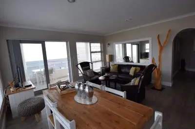 a living room with a table and a couch at Apartment Dolphin House in Hermanus