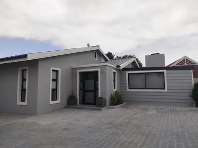 a gray house with a driveway in front of it at Hermanus C-Escape Apartment in Hermanus