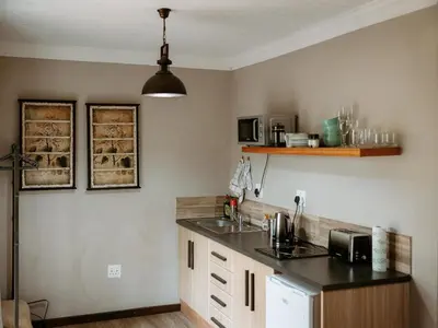 a kitchen with a sink and a counter top at Franschhoek Farm Cottages in Franschhoek