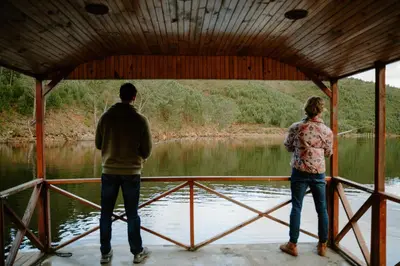 two people looking out over a body of water at Elgin River Lodge in Elgin