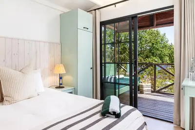a bedroom with a bed and a sliding glass door at Elgin River Lodge in Elgin