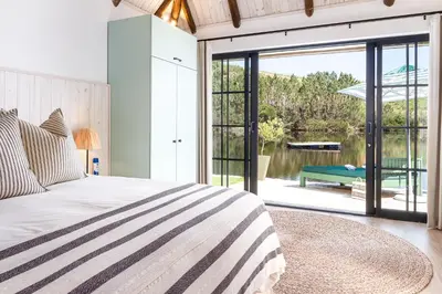 a bedroom with a bed and a sliding glass door at Elgin River Lodge in Elgin