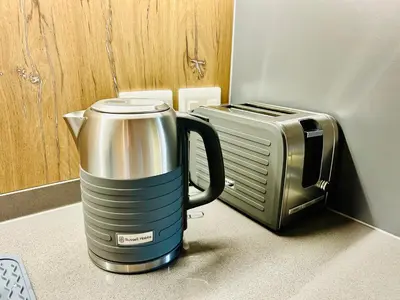 a coffee pot sitting next to a microwave at Cape Town Studio for business travel in Cape Town