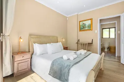a bedroom with a large bed with towels on it at 97 Drommedaris by Host Agents in Cape Town