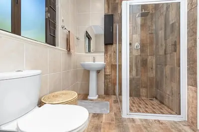 a bathroom with a shower and a toilet and a sink at 97 Drommedaris by Host Agents in Cape Town