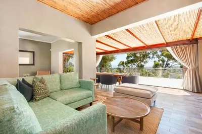 a living room with a couch and a table at 97 Drommedaris by Host Agents in Cape Town