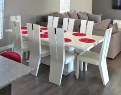a white dining room table with white chairs and a couch at 53 hillcrest in Oakdale
