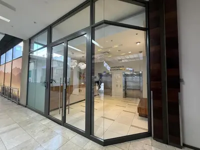 a hallway with glass doors in a building at Sonvanger Studio at Andringa Mall Luxury Apartments in Stellenbosch