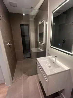 a bathroom with a sink and a shower with a mirror at 18 On Louvre Guesthouse in Paarl
