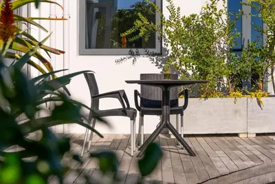 a table and two chairs on a patio at ocean12 Guesthouse Sunset Beach in Cape Town