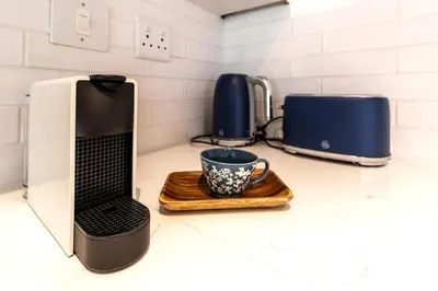 a coffee maker and a cup on a counter at Tram Vibes in Franschhoek