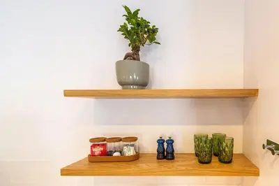 a shelf with vases and a potted plant on it at Tram Vibes in Franschhoek