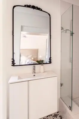 a bathroom with a white sink and a mirror at Tram Vibes in Franschhoek