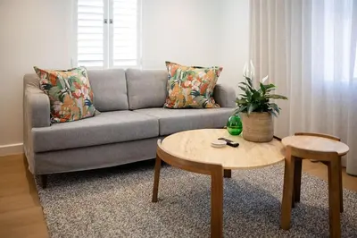 a living room with a couch and a table at One on Main in Franschhoek