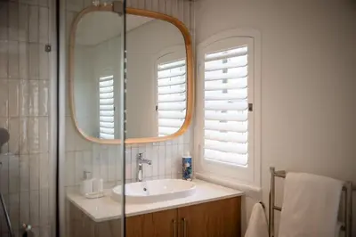 a bathroom with a sink and a mirror at One on Main in Franschhoek