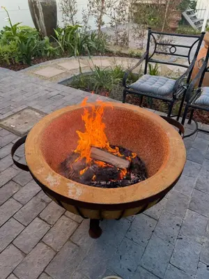a fire pit on a patio with two chairs at Yellow Wood 1 in Hermanus