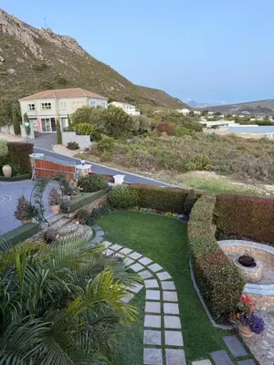 a garden with a pathway and a house at Yellow Wood 1 in Hermanus