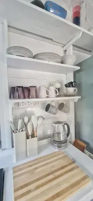 a refrigerator filled with dishes and bowls and utensils at Oh so Heavenly in Cape Town