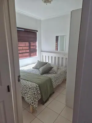 a bedroom with a bed and a window at Remmys Flat in Goodwood