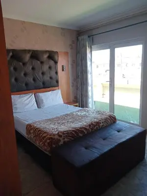 a bedroom with a large bed with a large window at Lookout Star Legend Accommodation in Parow