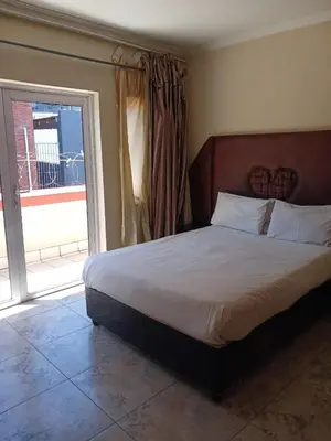 a bedroom with a bed and a large window at Lookout Star Legend Accommodation in Parow