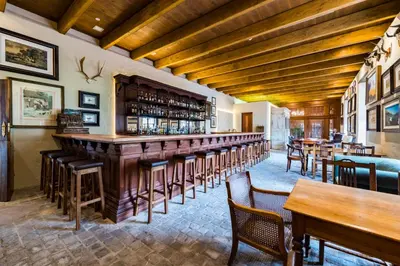 a bar in a restaurant with tables and chairs at Lanzerac Hotel & Spa in Stellenbosch