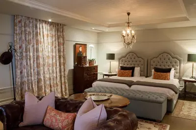 a bedroom with two beds and a couch at Lanzerac Hotel & Spa in Stellenbosch