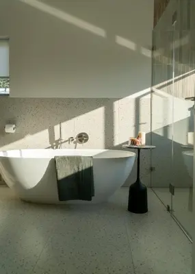 a white tub in a bathroom with a glass wall at 6 on Heide in Franschhoek