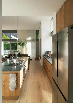 a kitchen with wooden floors and a stainless steel refrigerator at 6 on Heide in Franschhoek