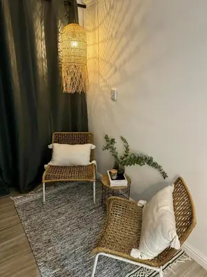 a living room with two chairs and a rug at Little Heaven in Cape Town