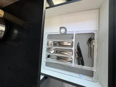 an open refrigerator with knives and utensils in it at Little Heaven in Cape Town