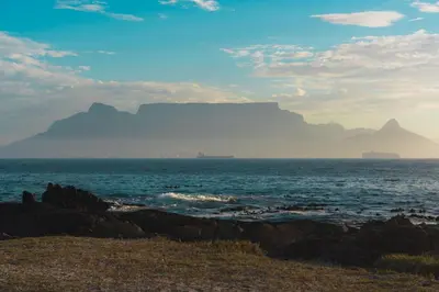 a view of the table mountain from the beach at Studio Apartment - Dolphin Beach in Cape Town