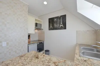 a kitchen with a sink and a counter top at Studio Apartment - Dolphin Beach in Cape Town