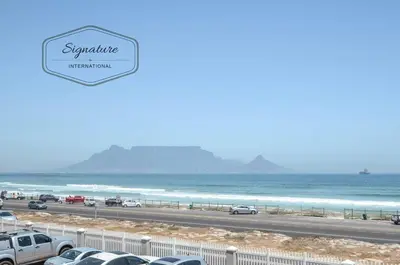 a view of the beach and the ocean at 2 Bedroom Apartment - Zeezicht Blouberg in Cape Town