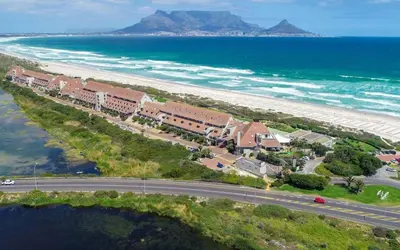 an aerial view of a resort on the beach at Modern 2 Bedroom Apartment At Dolphin Beach in Cape Town