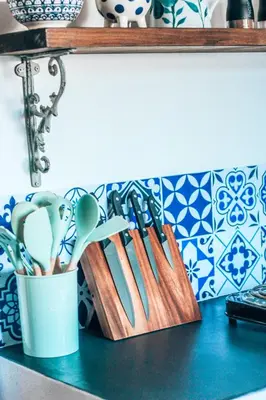 a bunch of utensils in a container on a counter at Amulet At The Sea in Hermanus