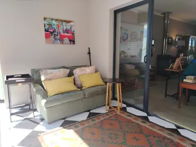 a living room with a couch and a mirror at Columbus Whales in Hermanus