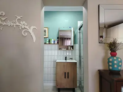 a bathroom with a sink and a mirror at Columbus Whales in Hermanus
