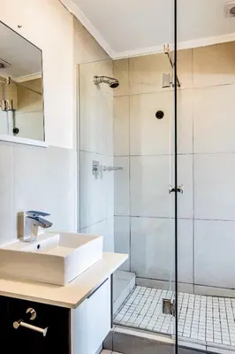 a bathroom with a sink and a shower at Canalside Tranquility in Cape Town