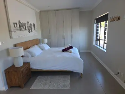 a bedroom with a bed with a book on it at Dolphin Paradise in Cape Town