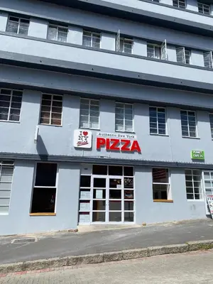 a white building with a pizza sign on it at Granaat Pit - Paarl - Self Catering Apartment in Paarl