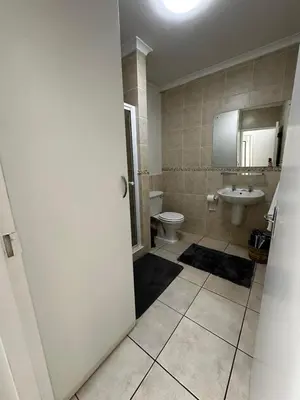 a bathroom with a toilet and a sink at Seaside Serenity in Cape Town