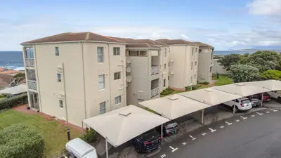 an overhead view of a building with umbrellas in a parking lot at 258 Hermanus Beach club in Hermanus